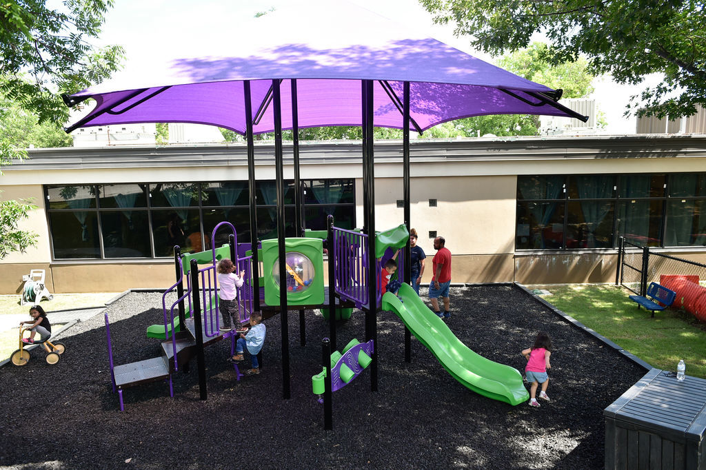 Children have fun on a newly built play area at Fred Moore Day Nursery School. Floyd Smith Concrete is the company that built the play area at Fred Moore Day Nursery School. The company is building it through a grant.